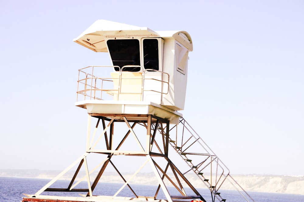 a lifeguard tower sitting on top of a boat in the ocean
