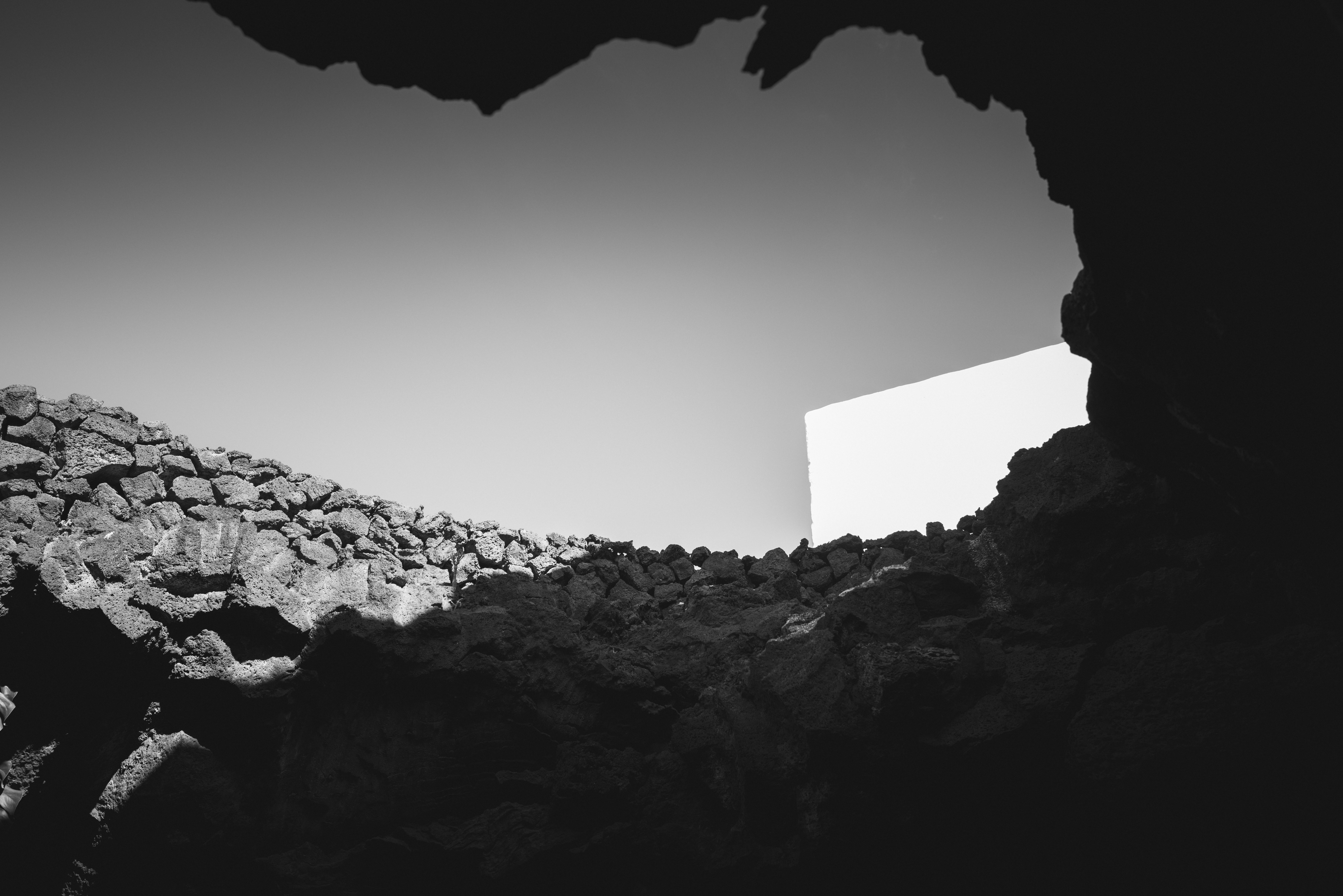 a black and white photo of a rock wall