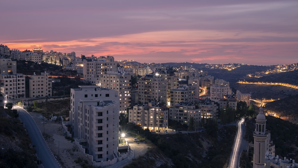 a view of a city at night from a hill