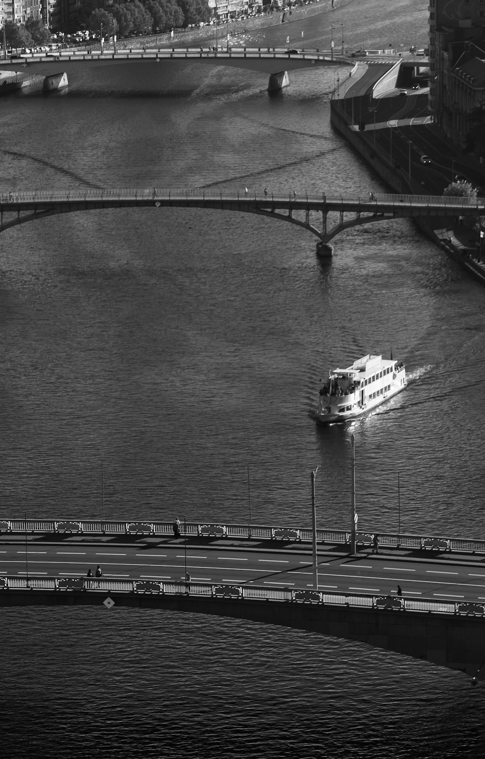 a boat traveling down a river next to a bridge