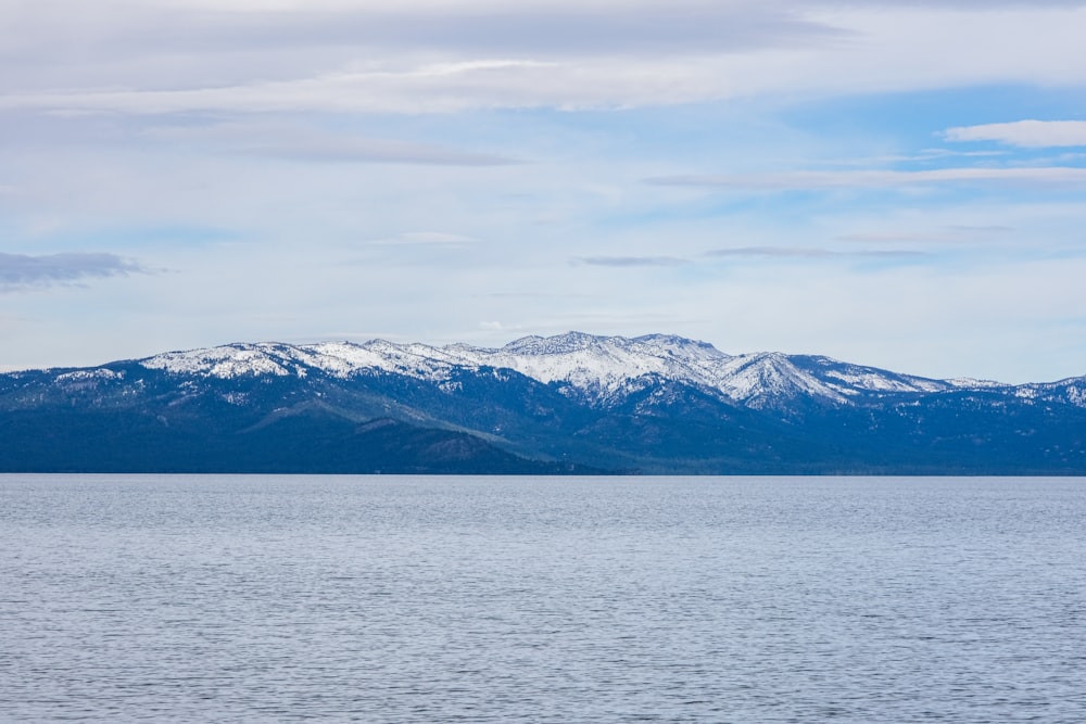 a large body of water with mountains in the background