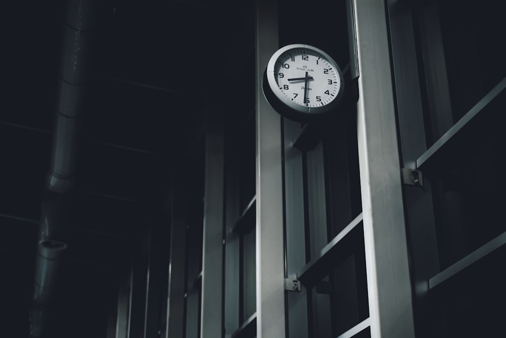 a clock hanging from the side of a building