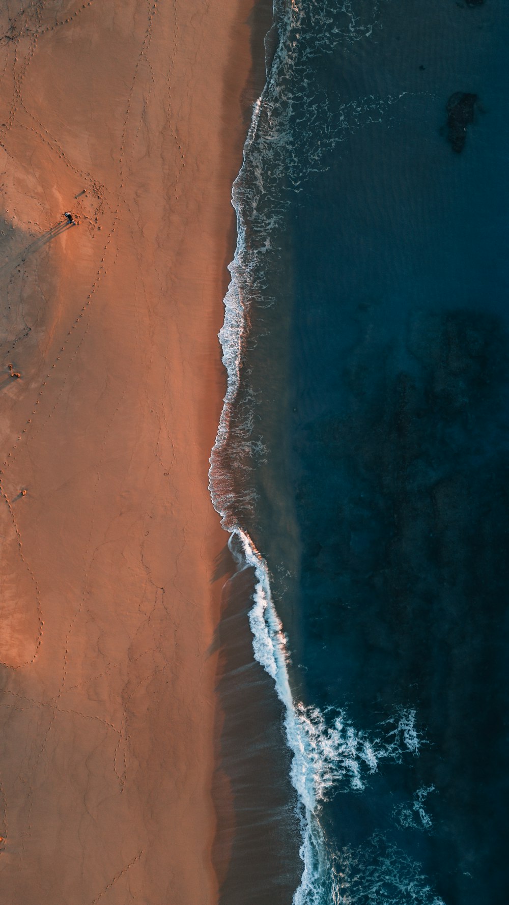 an aerial view of a sandy beach and ocean