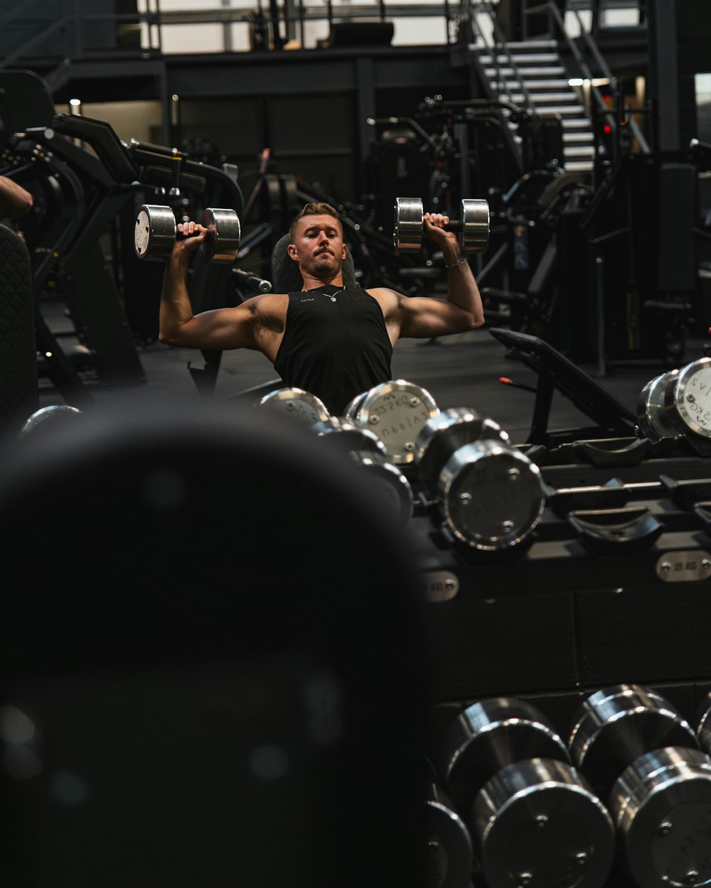 a man lifting a barbell in a gym