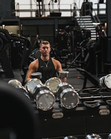 a man holding a cup in a gym
