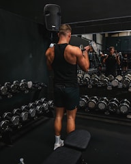 a man standing on a bench in a gym