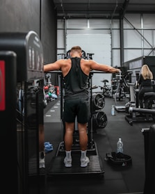 a man standing on a machine in a gym