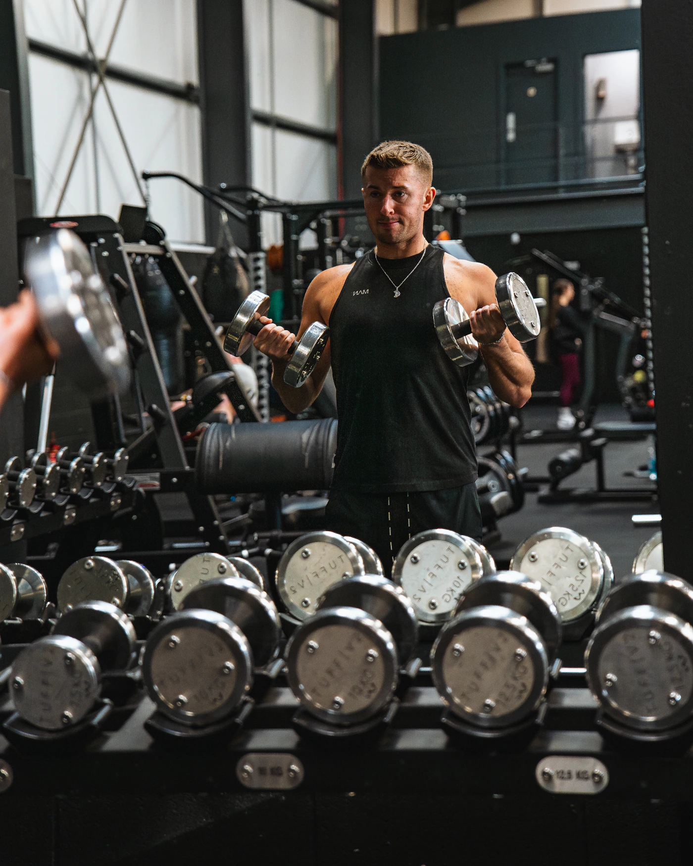 Athlete training with dumbbells