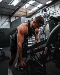 a man working out on a machine in a gym