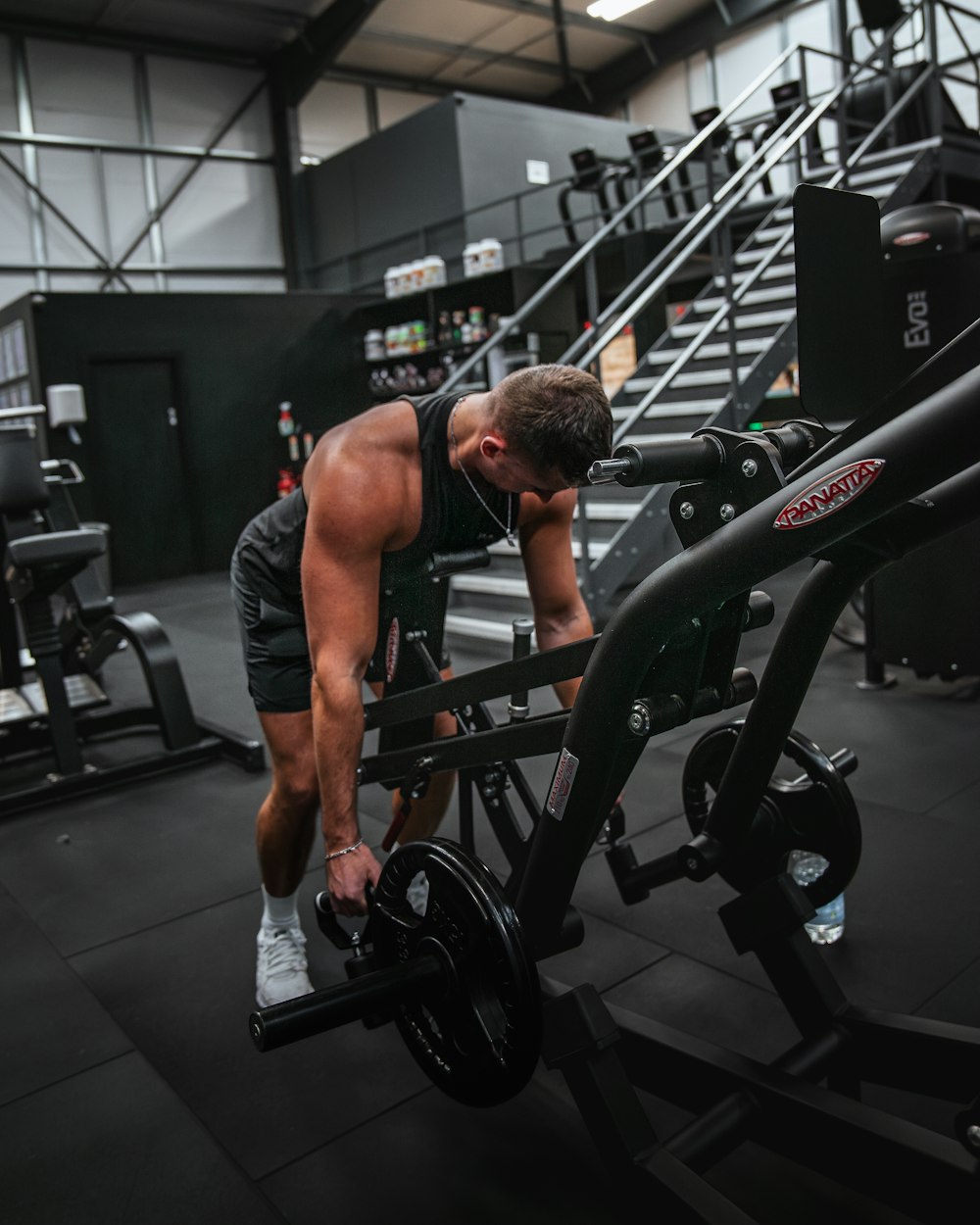 a man working out with a barbell in a gym