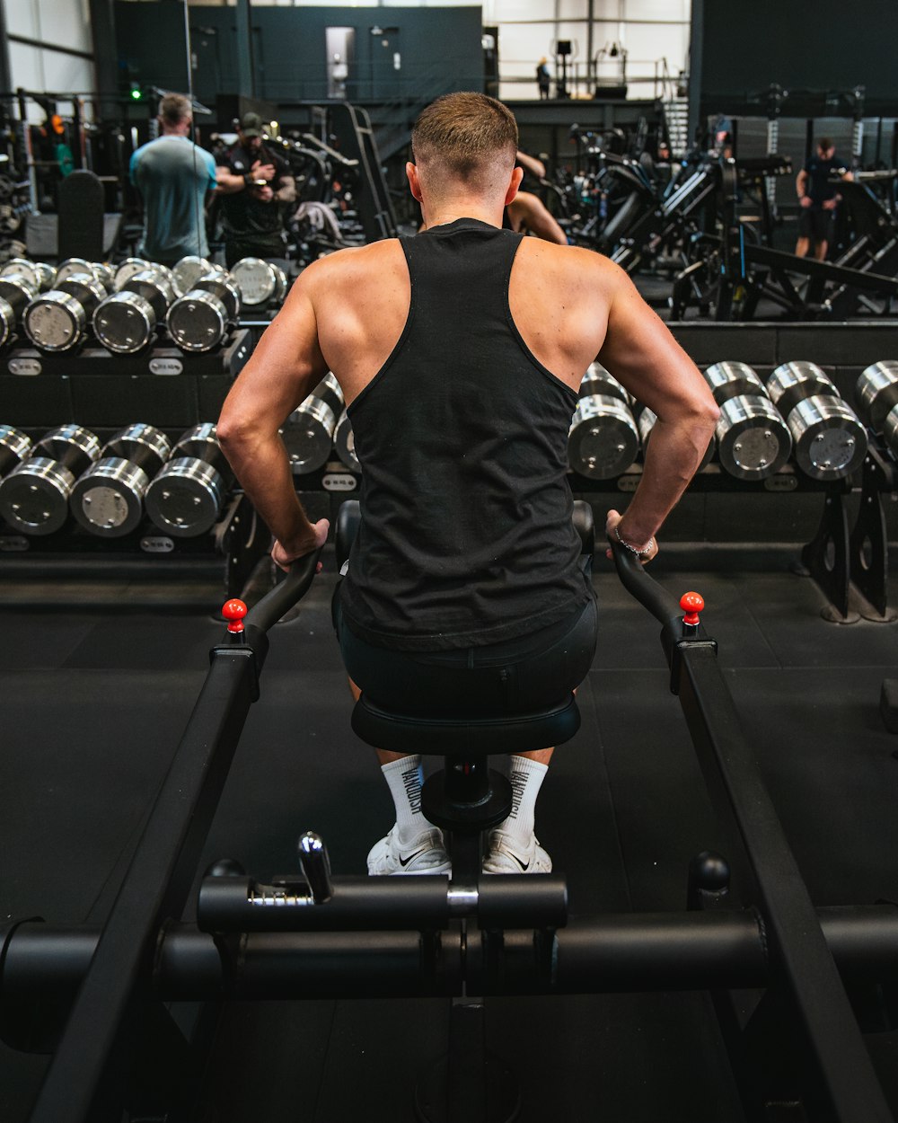 a man working out on a machine in a gym