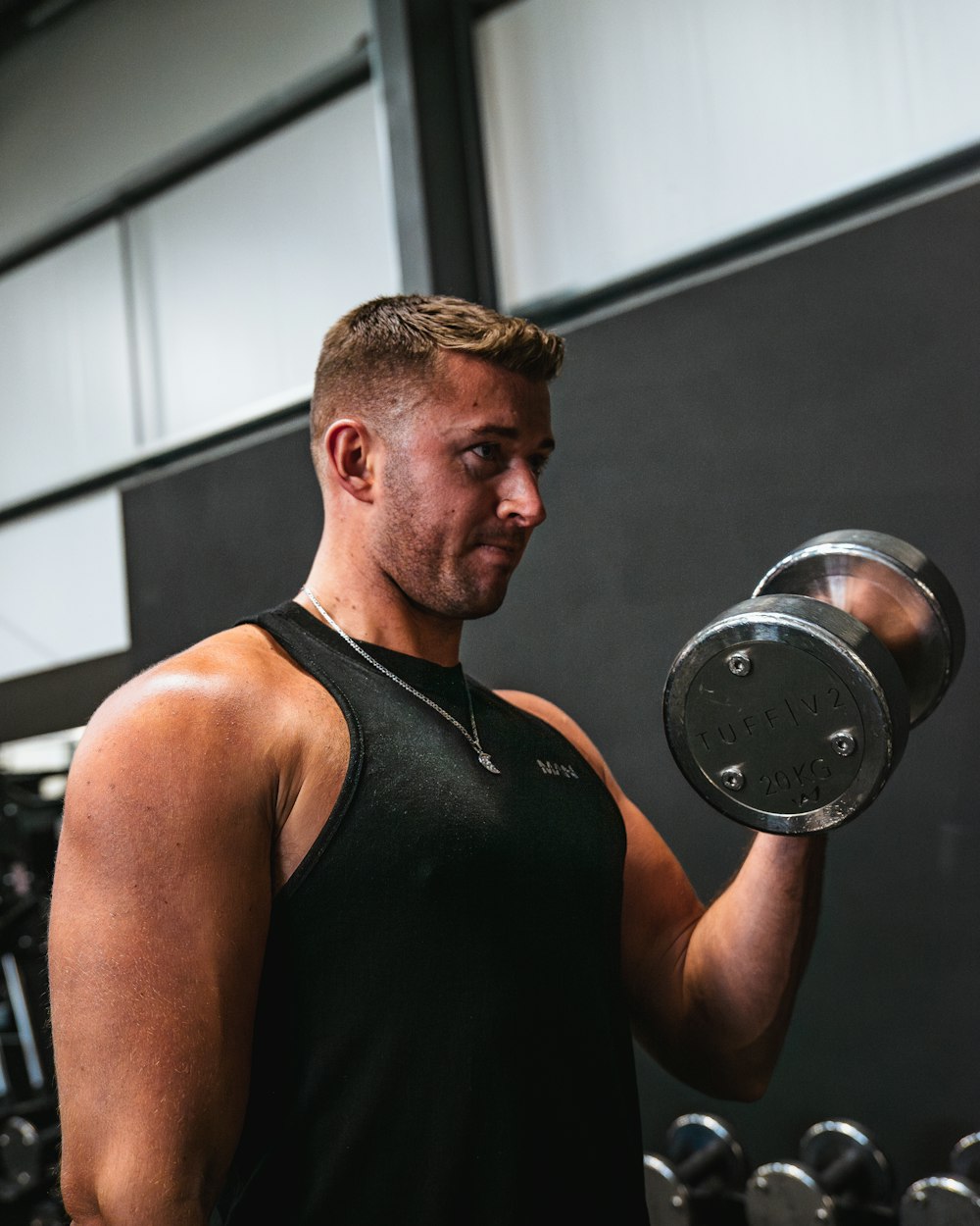 a man lifting a dumbbell in a gym