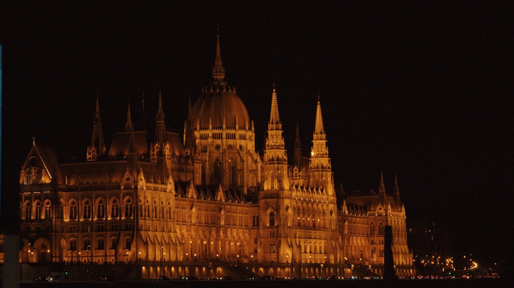 a large building lit up at night in the dark