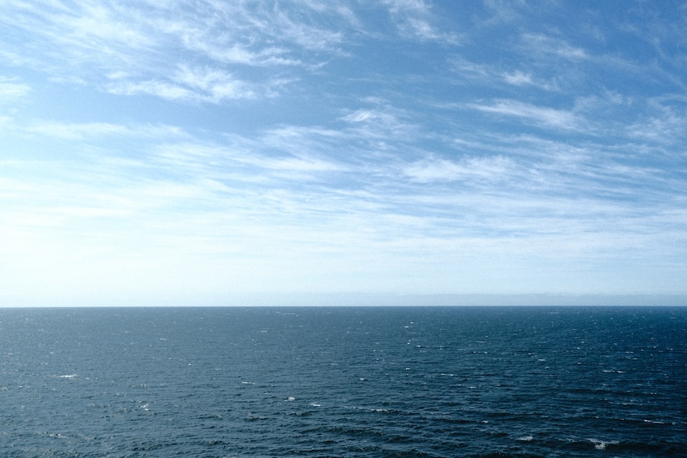 a large body of water under a blue sky