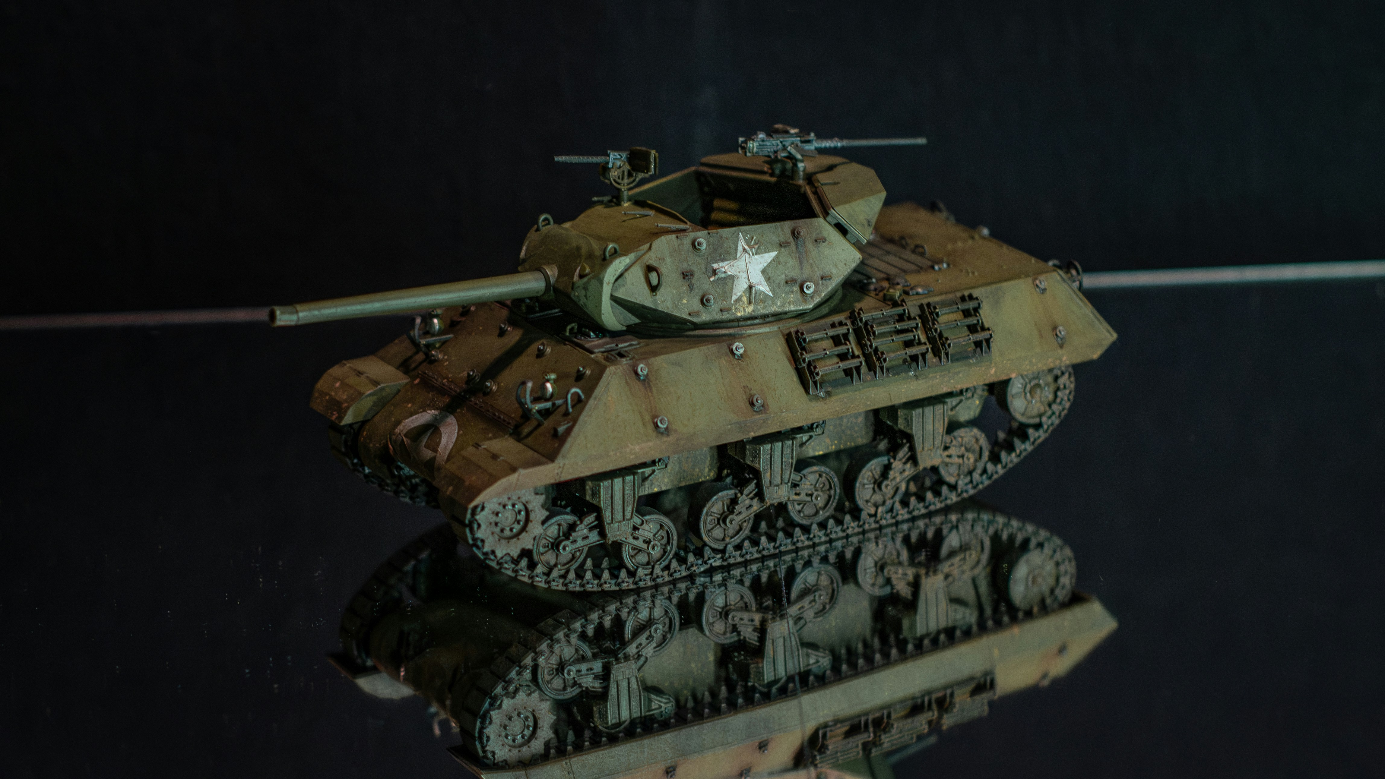 a close up of a tank on a reflective surface