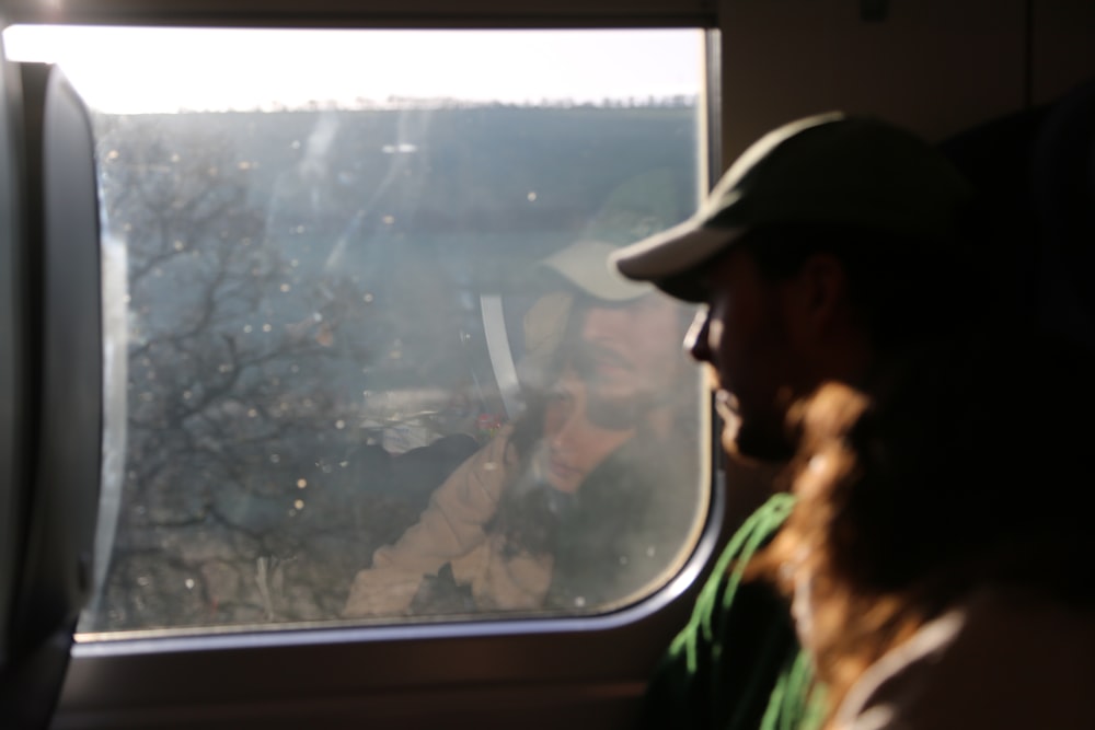 a man and a woman looking out a window