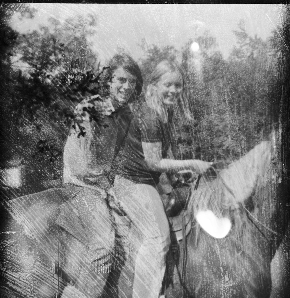 a couple of women riding on the back of a horse
