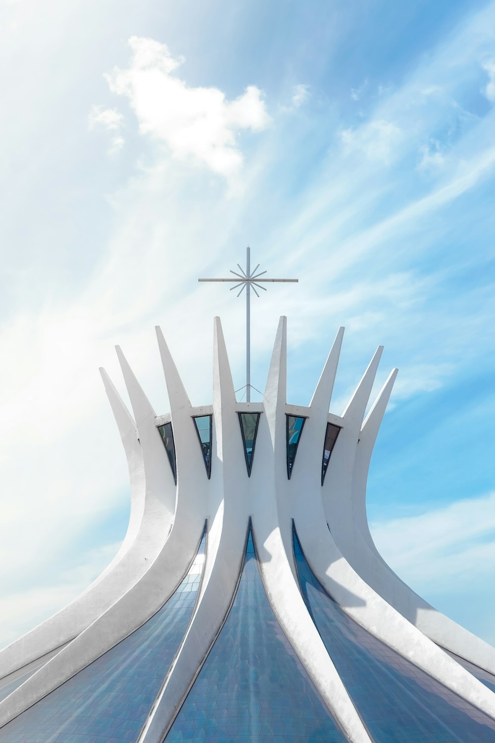 a large white building with a cross on top of it