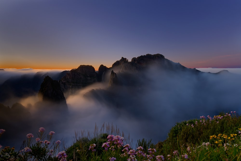 a view of a mountain covered in fog