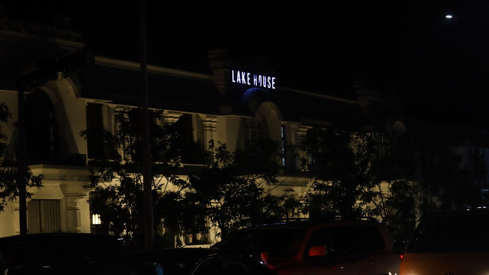 cars parked in front of a building at night