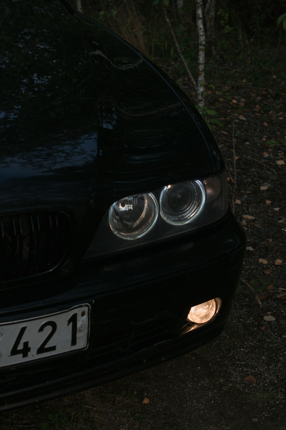 a close up of the headlights of a black car