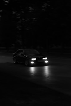 a car driving down a street at night