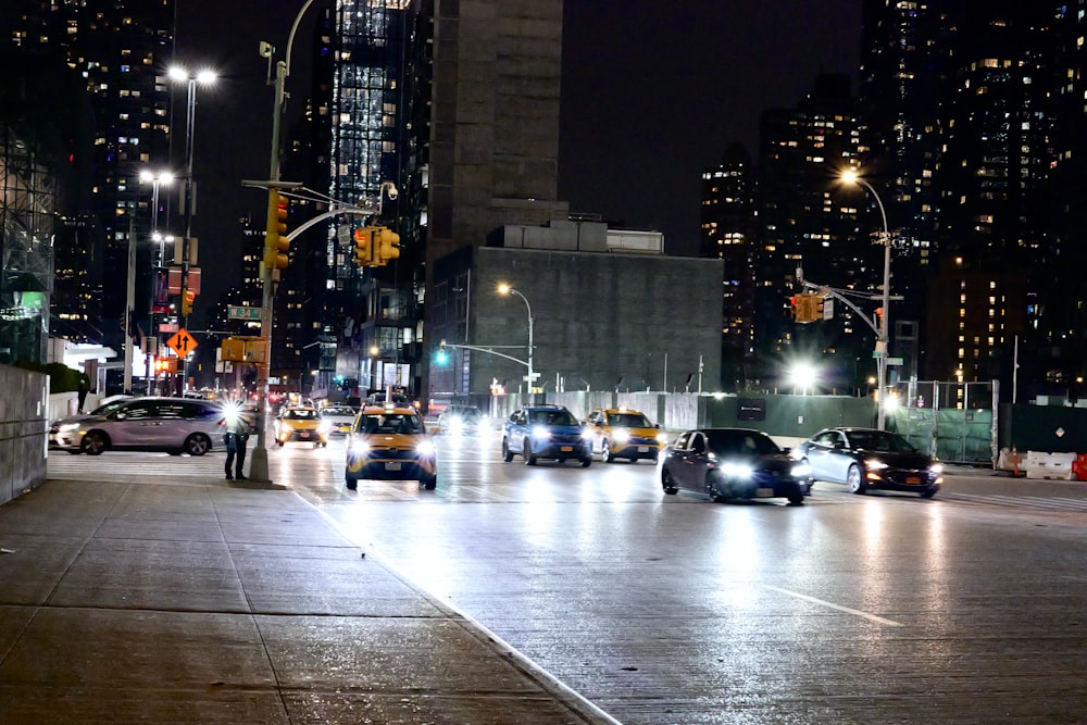 a city street filled with lots of traffic at night