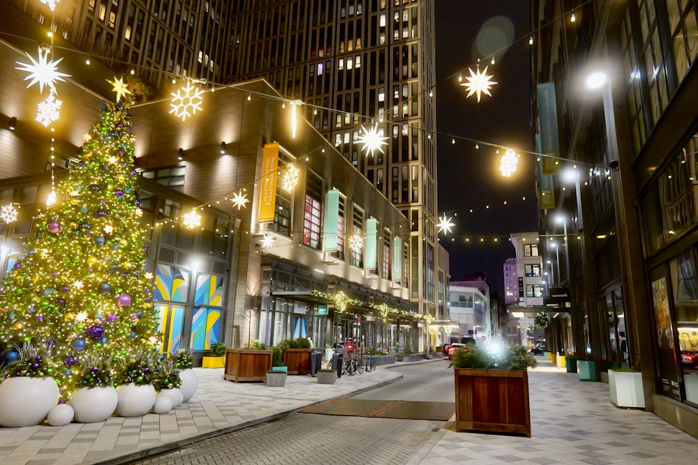 a decorated christmas tree on a city street