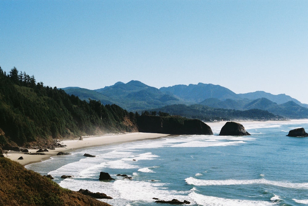 a view of a beach with mountains in the background