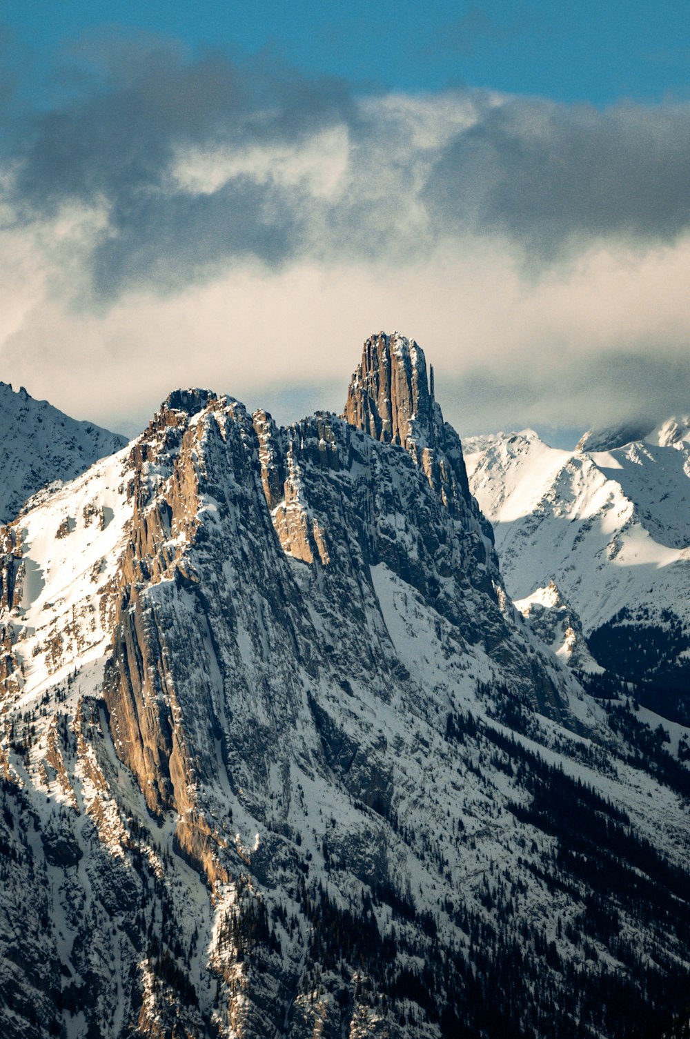 a snow covered mountain with a sky background