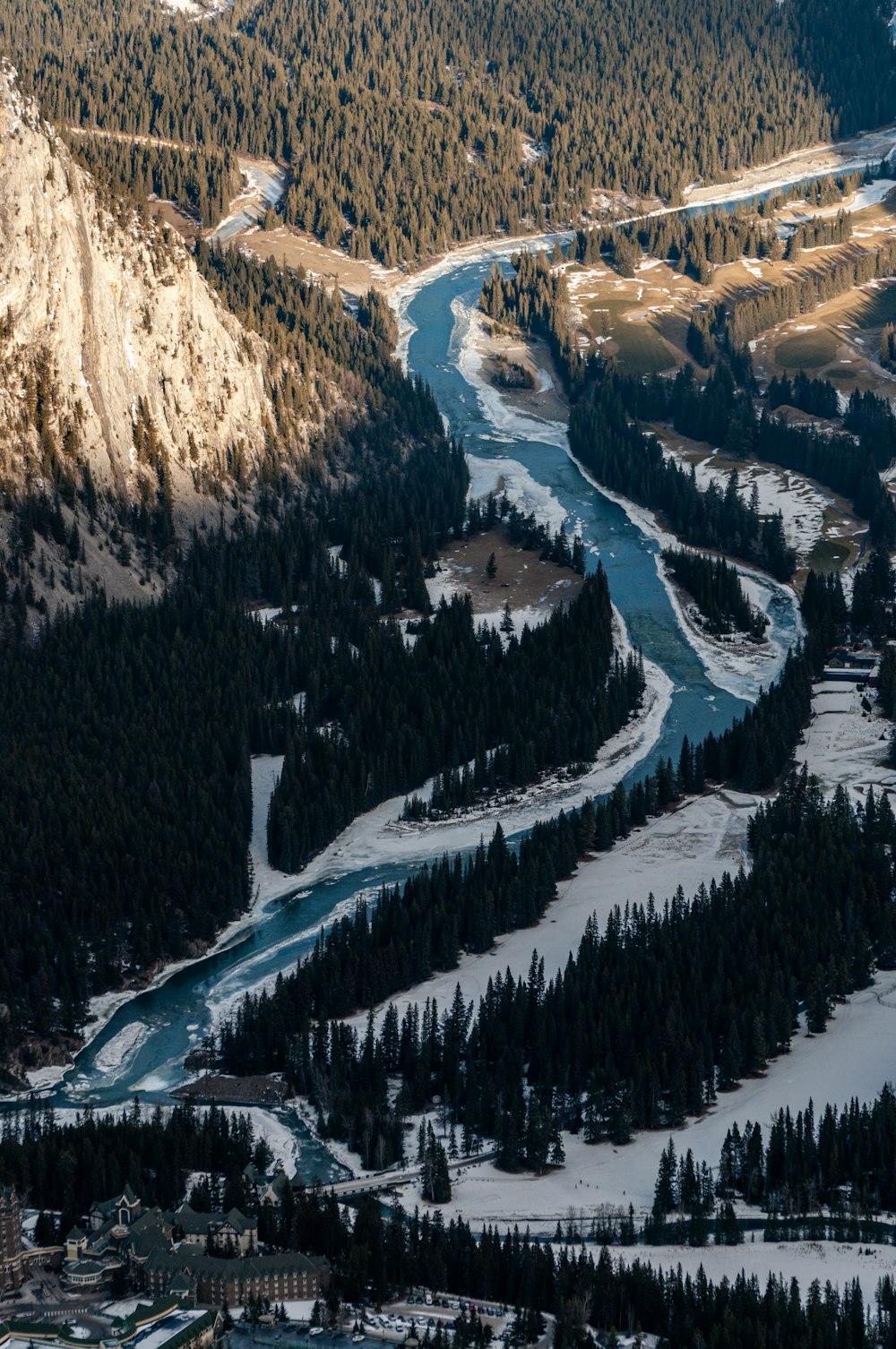 a river running through a valley surrounded by mountains