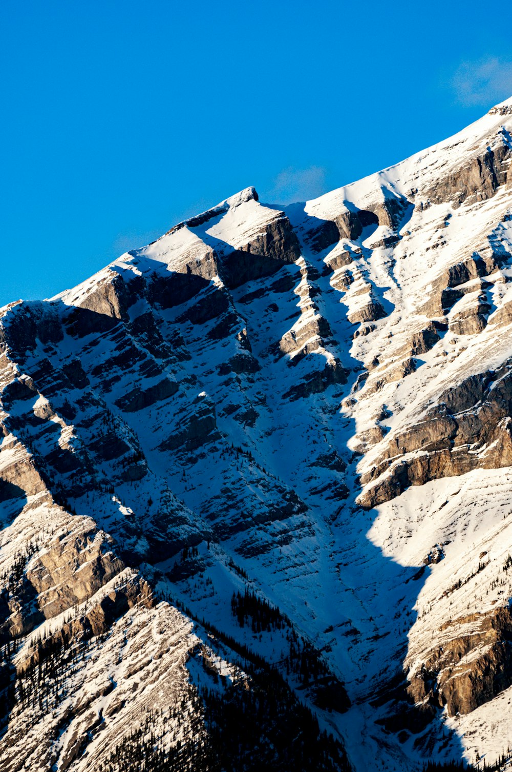 a snow covered mountain with a blue sky in the background