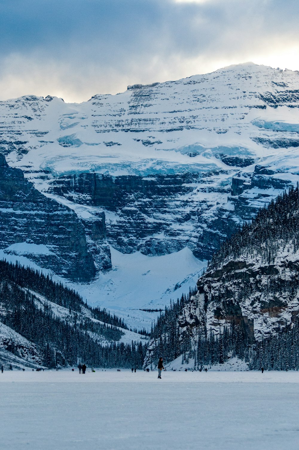 a group of people riding skis on top of a snow covered slope