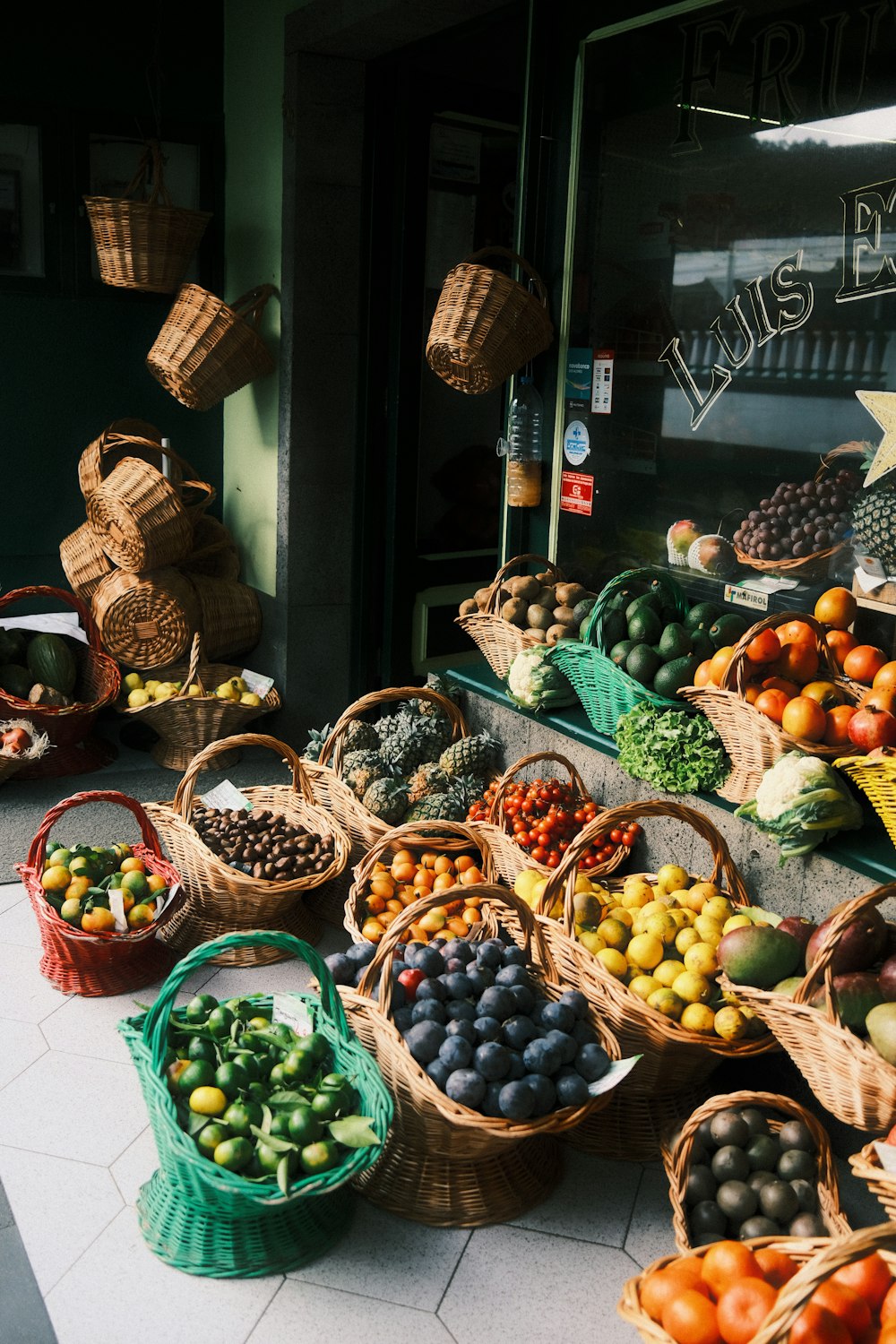 a bunch of baskets filled with different types of fruit