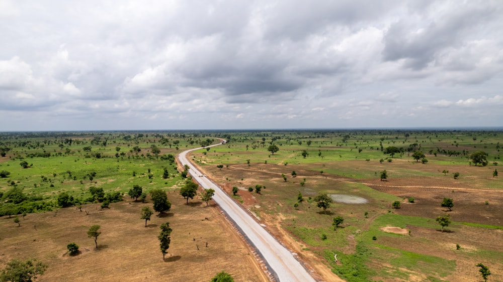 an aerial view of a road in the middle of a field