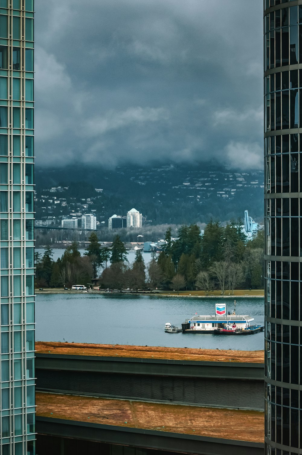 a boat floating on top of a lake next to a tall building