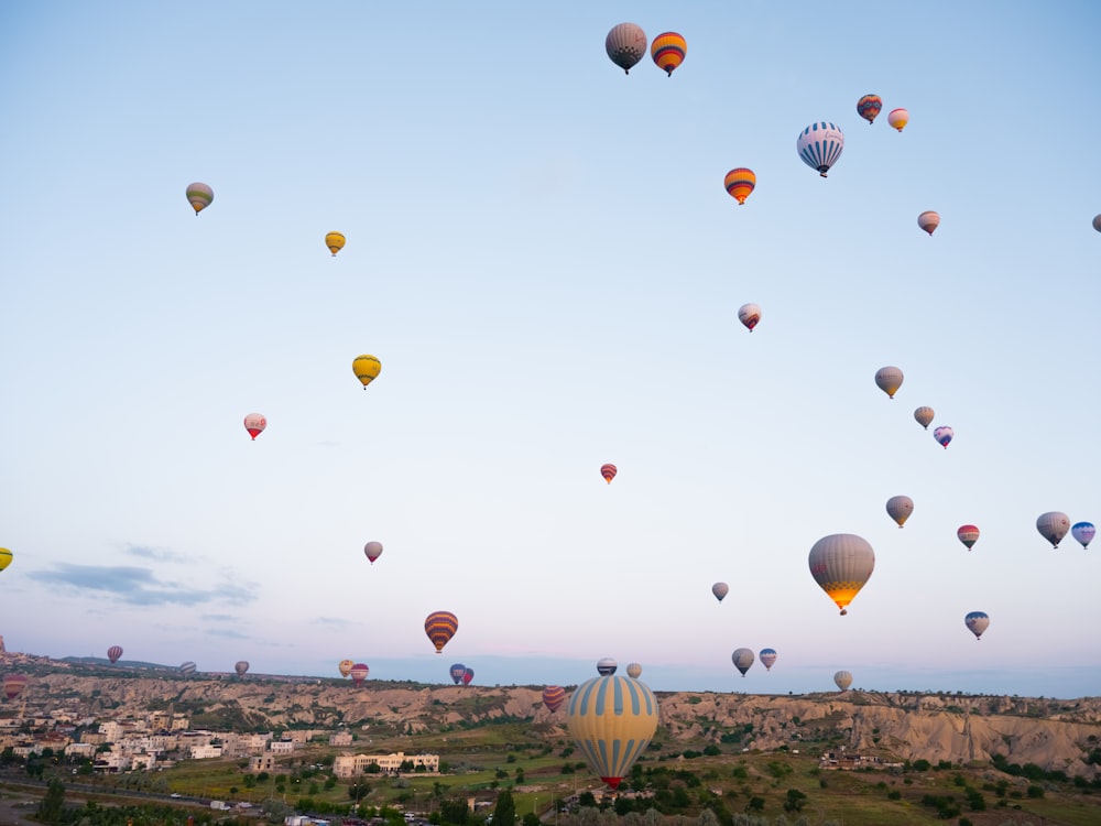 a bunch of hot air balloons flying in the sky