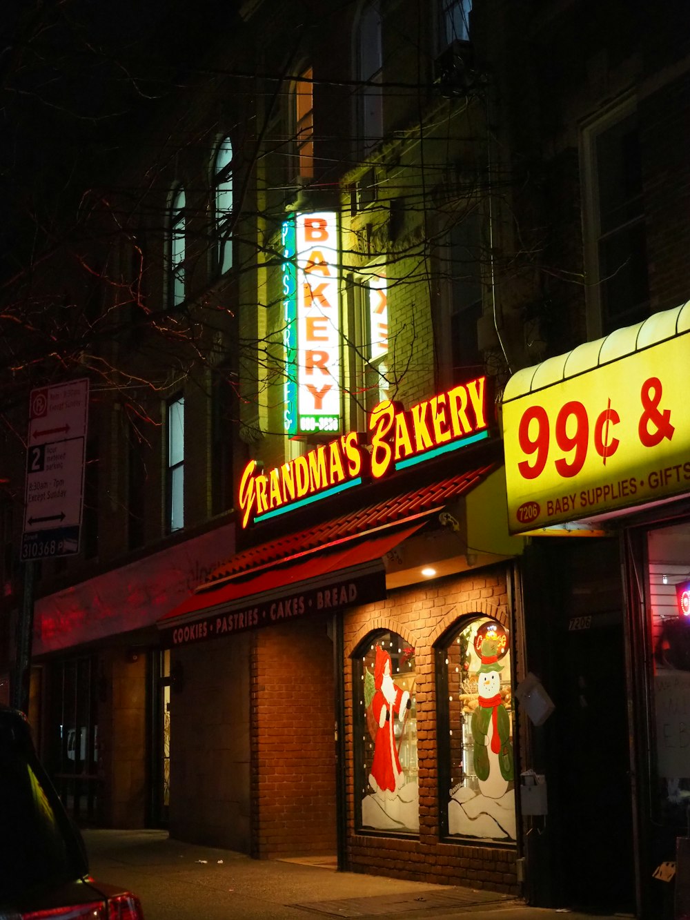 a store front at night with a neon sign