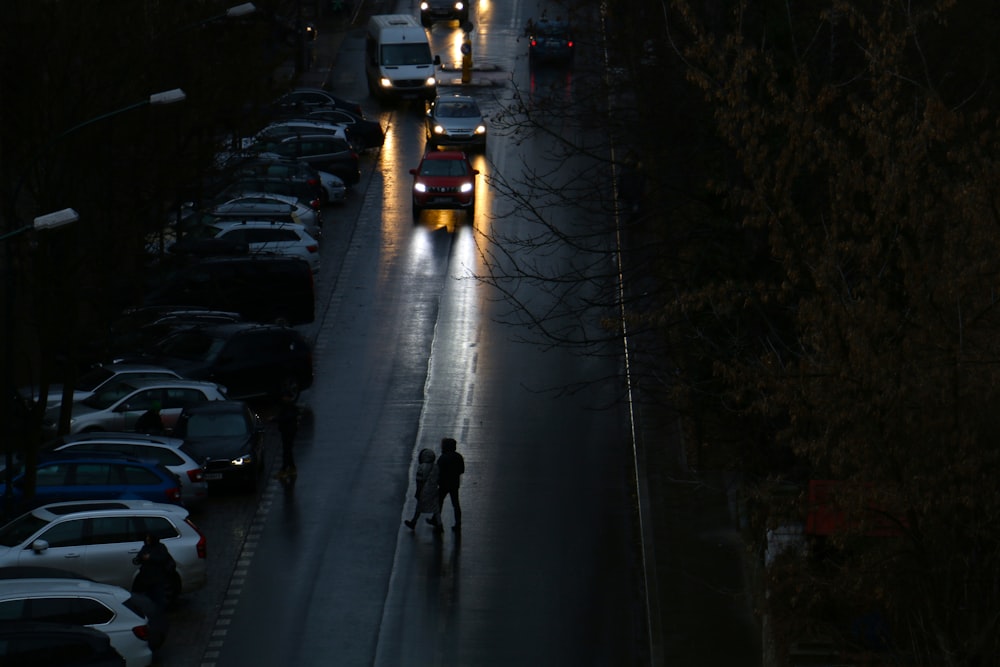 a person riding a skateboard down a street at night