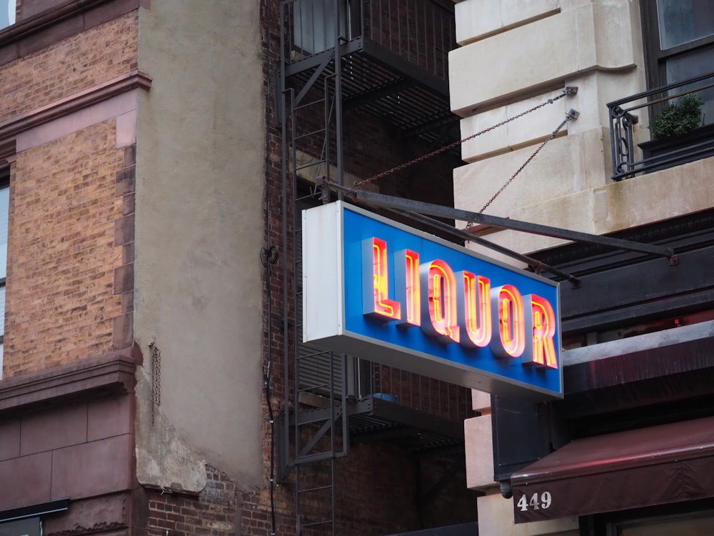 a neon sign for a liquor store on the side of a building