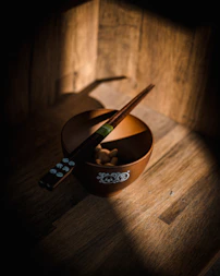 a bowl of food with chopsticks in it