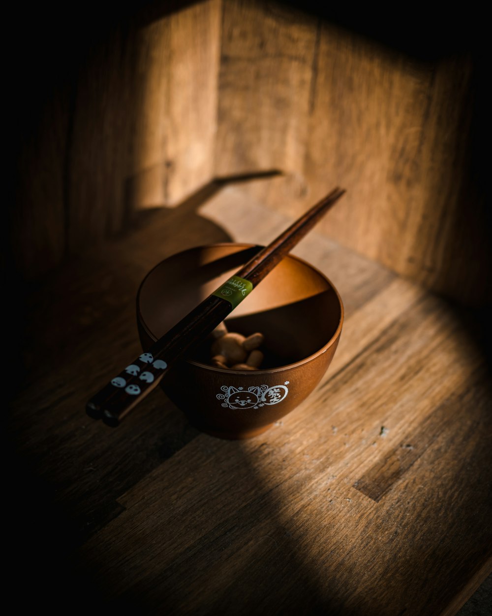 a bowl of food with chopsticks in it