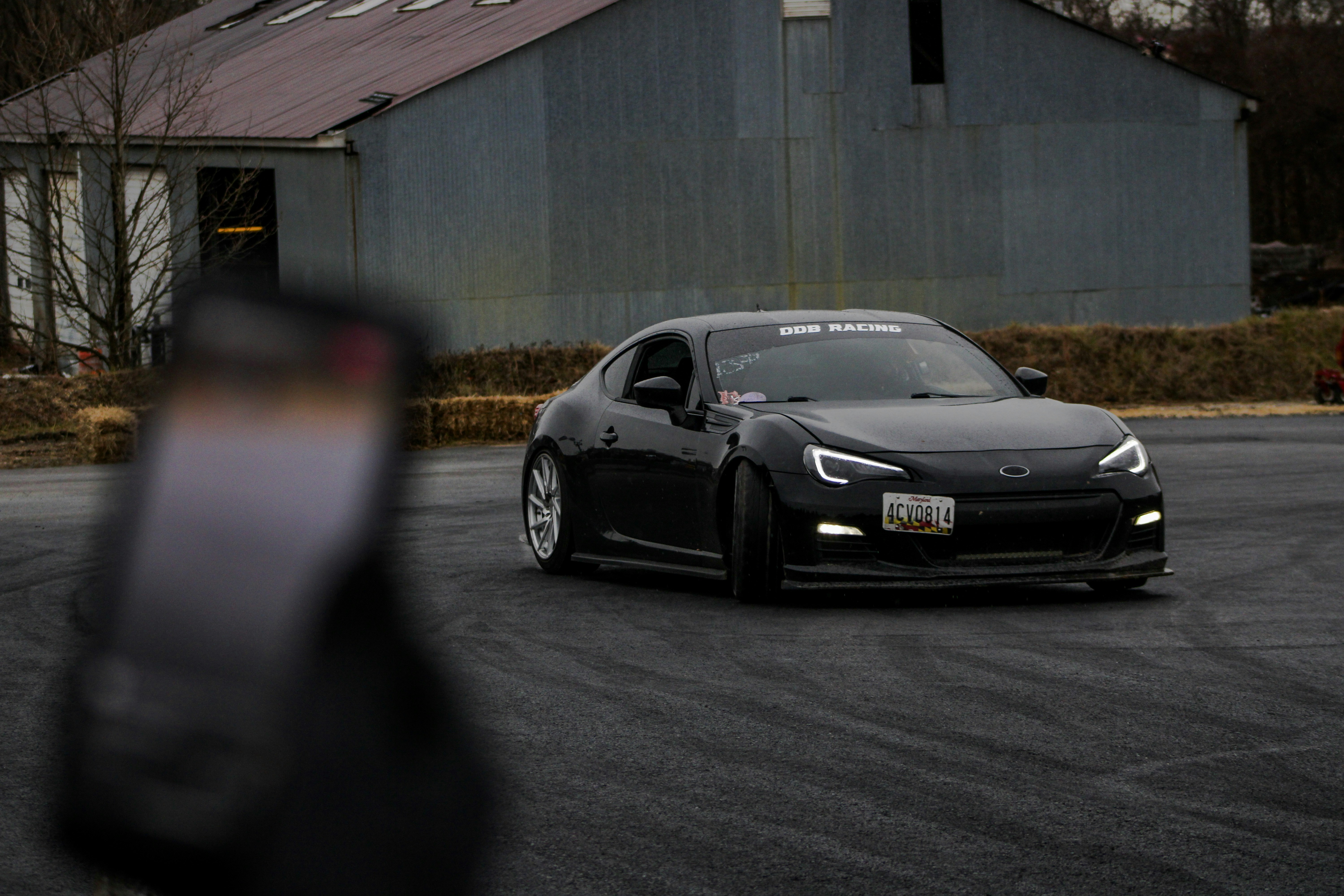 a black sports car parked in a parking lot