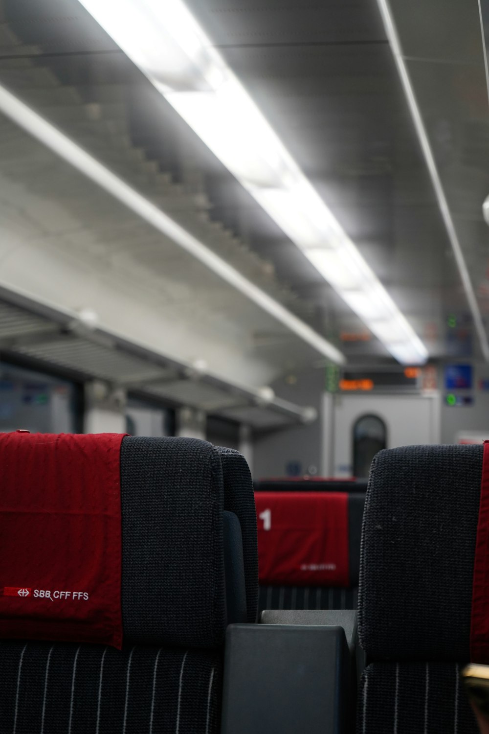 a row of seats with red covers on them