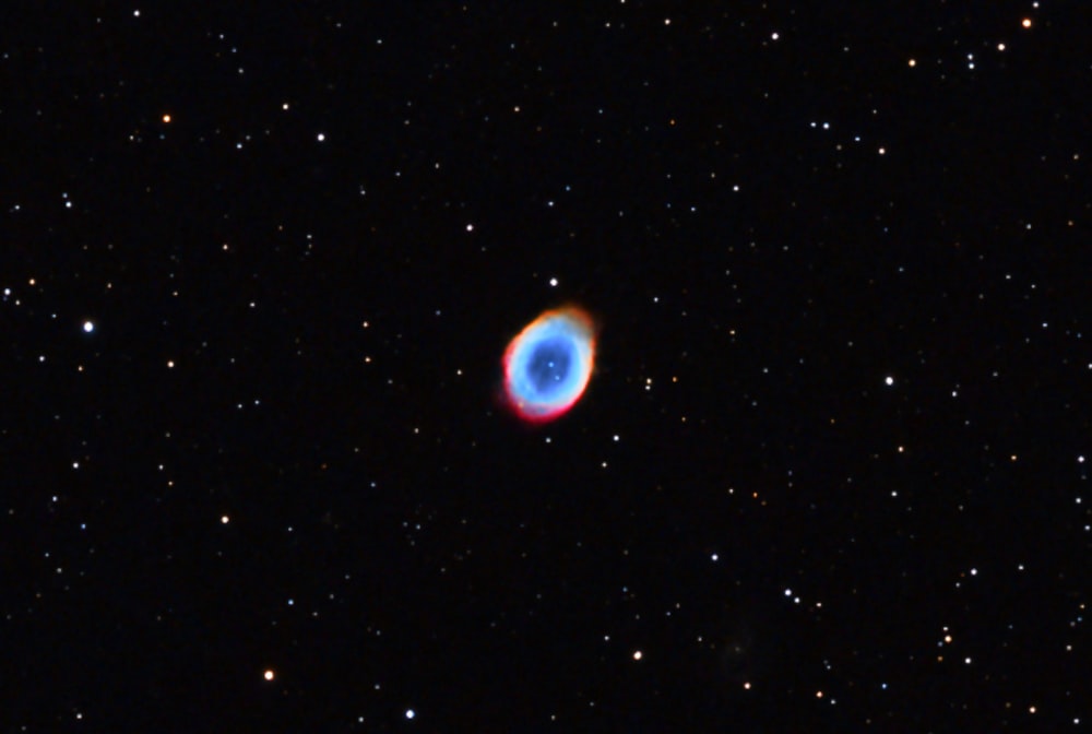 a blue ring in the middle of a black sky