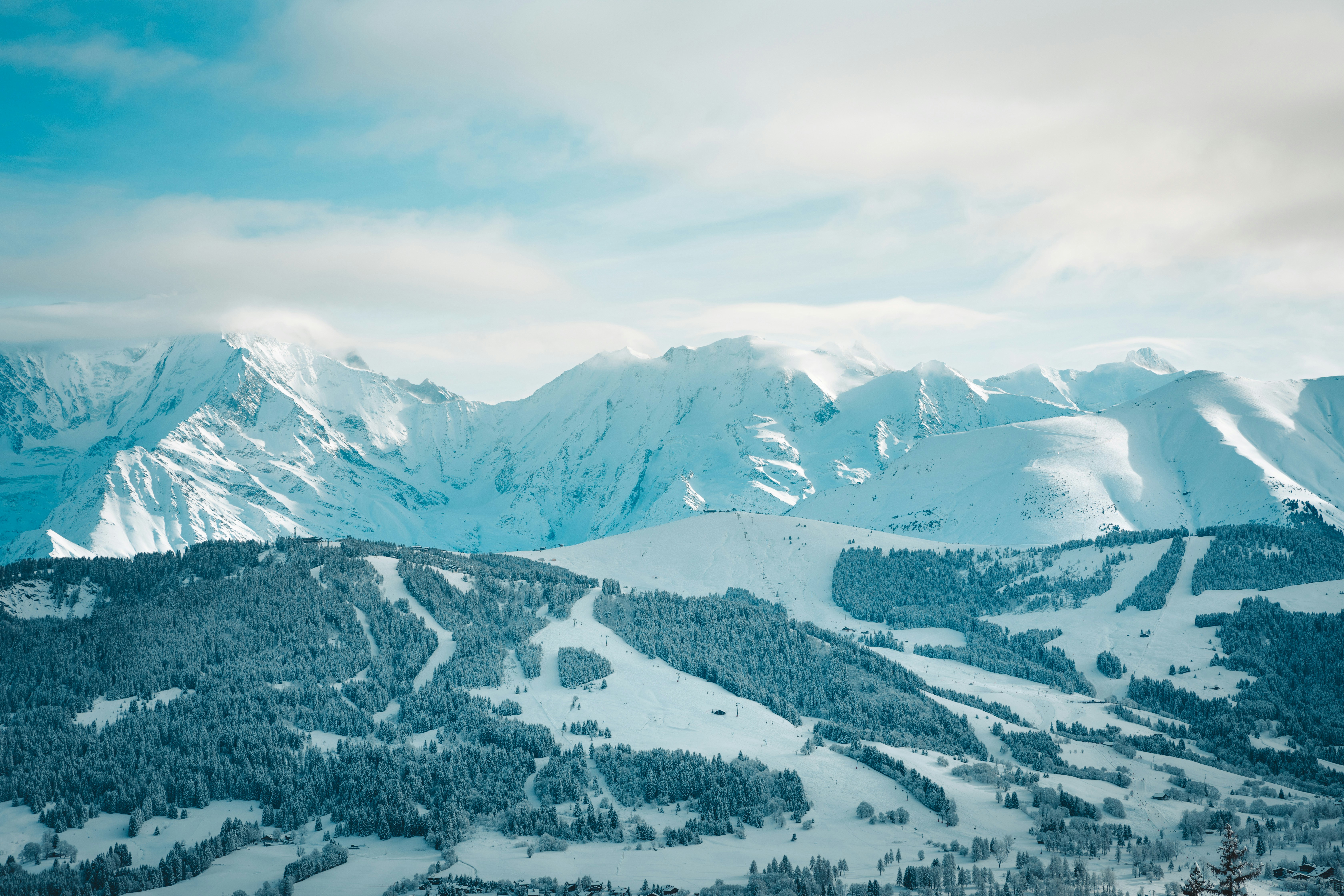 a view of a mountain range covered in snow