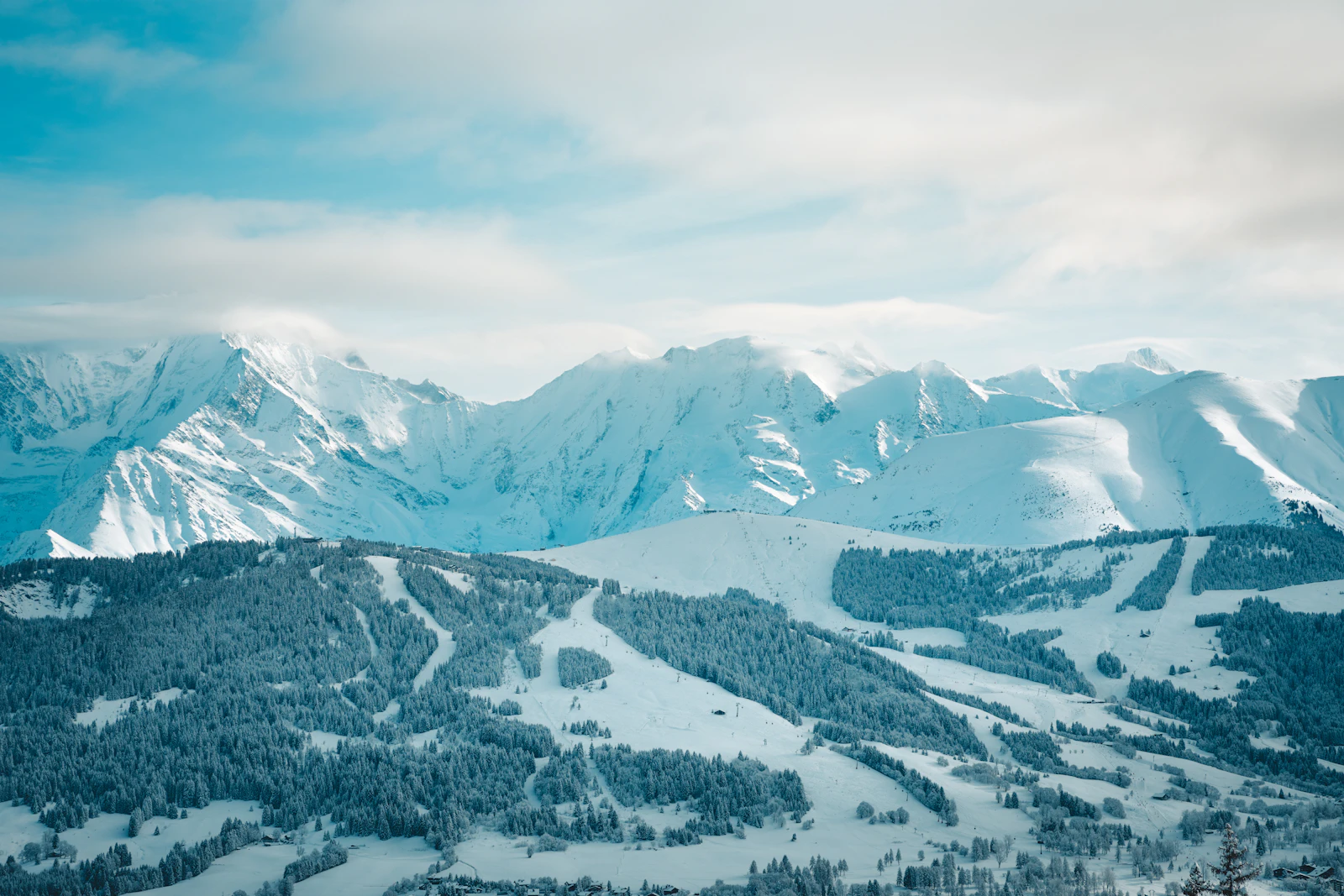 Snowy mountain range and forest around Megève