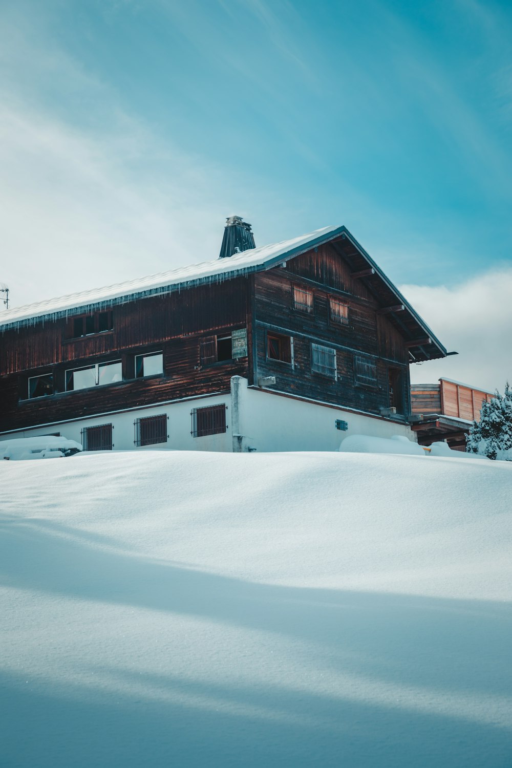 a house in the middle of a snowy field