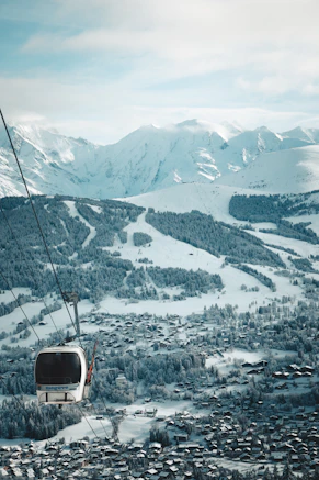 a ski lift going up a snowy mountain