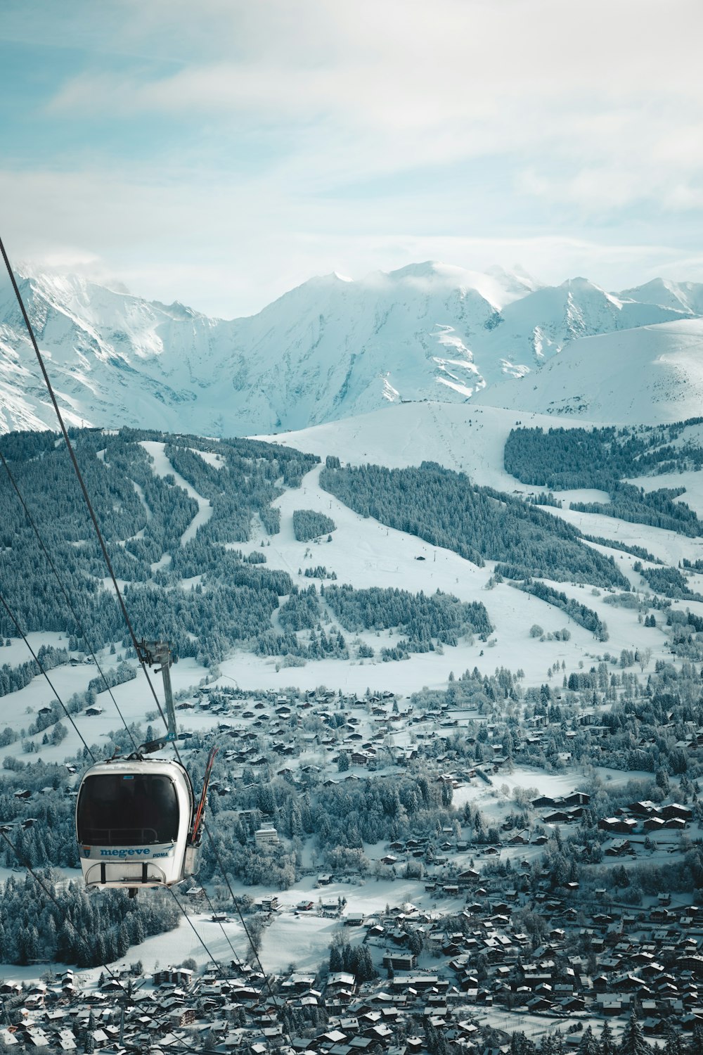 a ski lift going up a snowy mountain